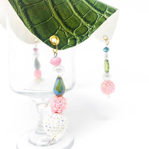 green crocodile skin textured drink cover with clear and pink beads on glass