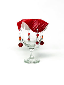 crocodile skin textured drink cover with white and crimson beads on glass,
