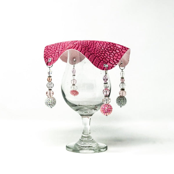 pink crocodile skin textured drink cover with clear and pink beads on glass