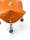 orange drink cover made from vegan leather with beautiful bead work on glass close-up