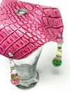 pink crocodile skin textured drink cover with green and pink beads on glass up close