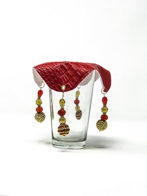 fiery red drink cover with yellow and red beads on glass