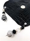 subtle black drink cover with silver and black beads off glass