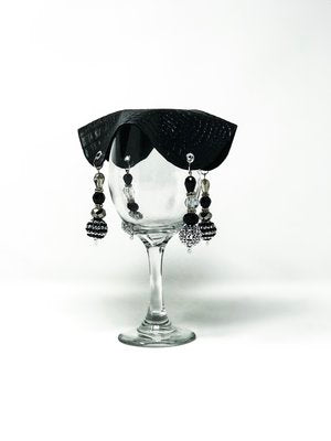 subtle black drink cover with silver and black beads on glass